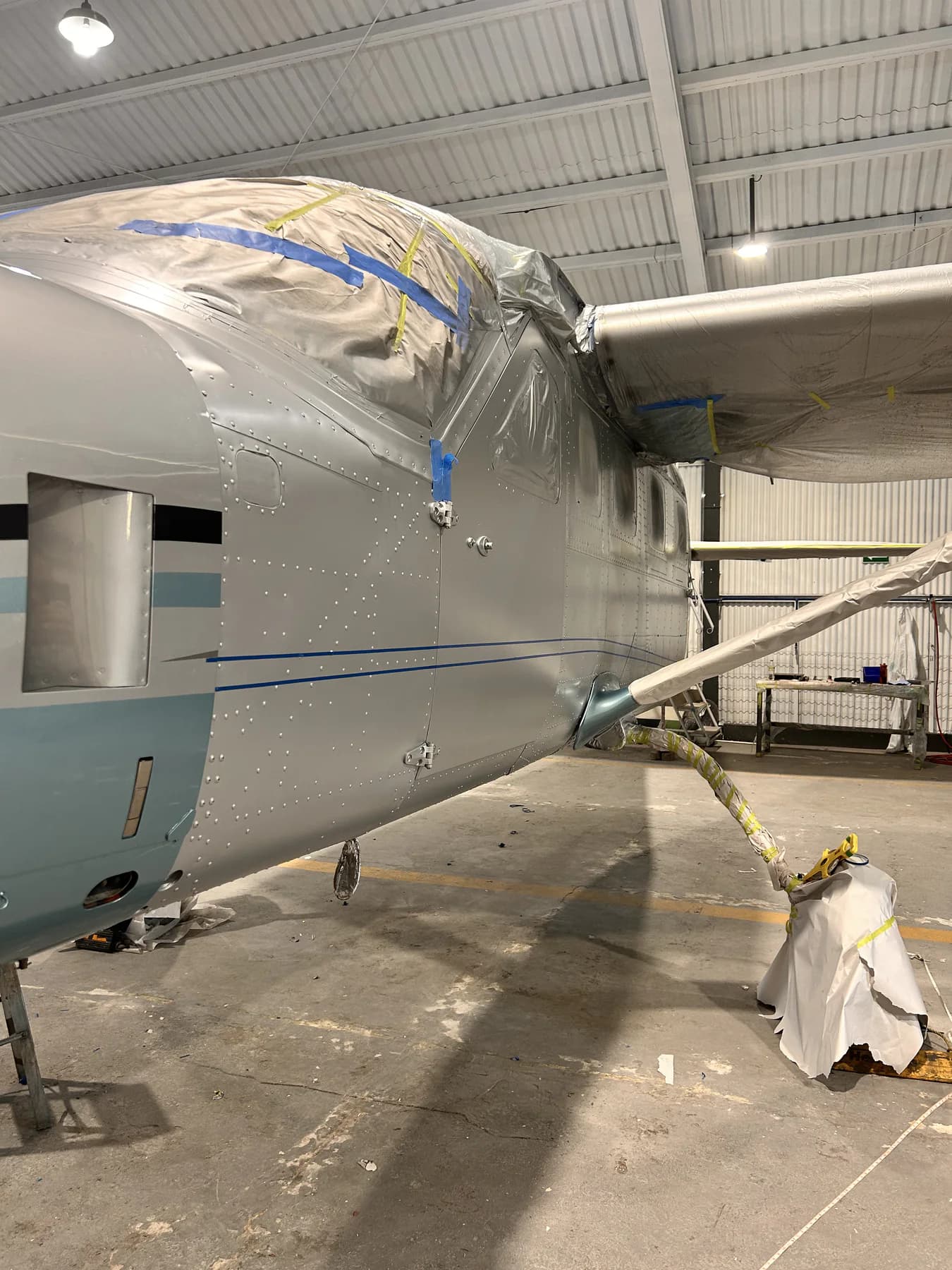Detailed aircraft surface refinishing work in progress