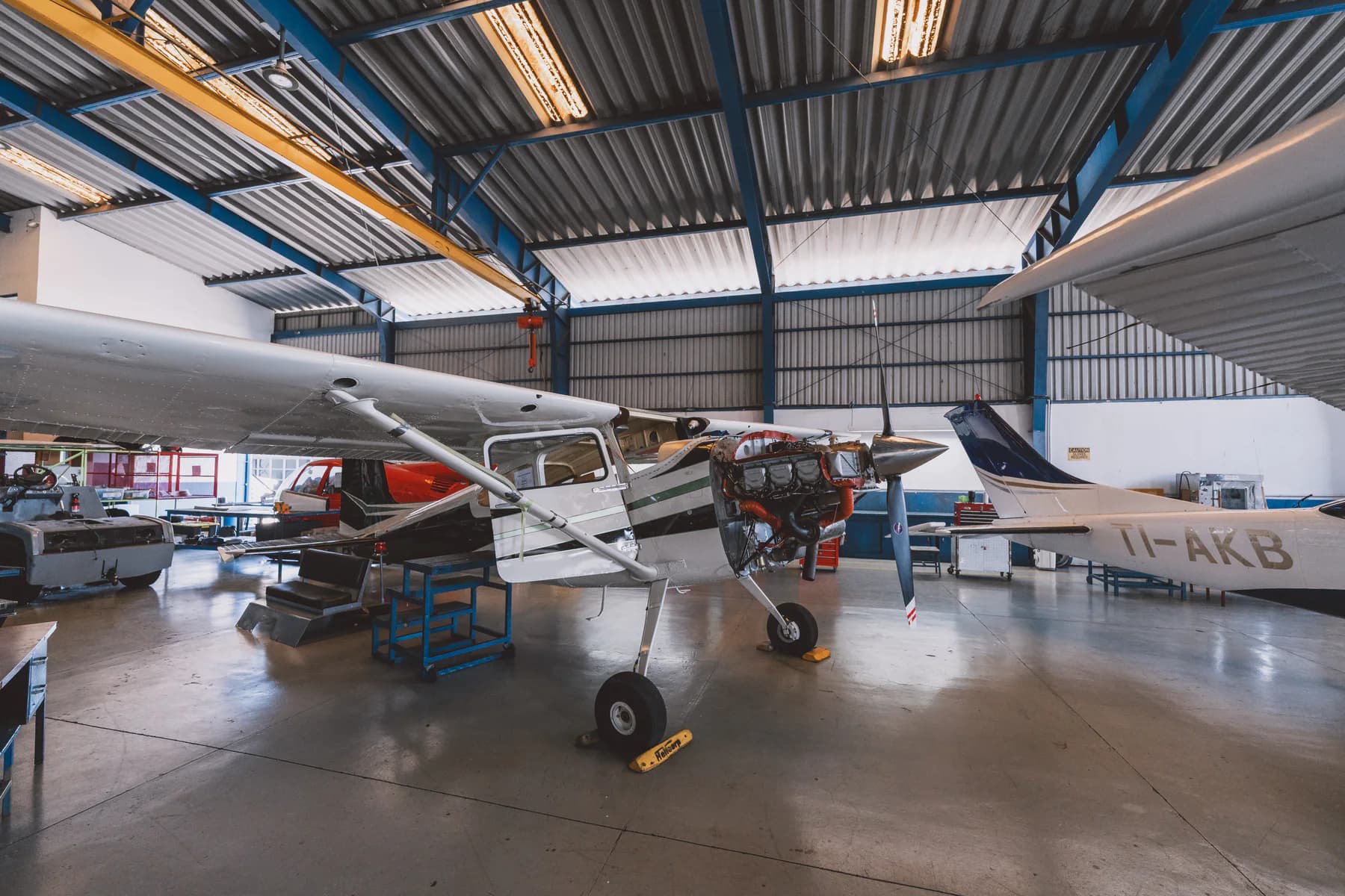 Fixed-wing aircraft undergoing maintenance inside the Aerocorp hangar